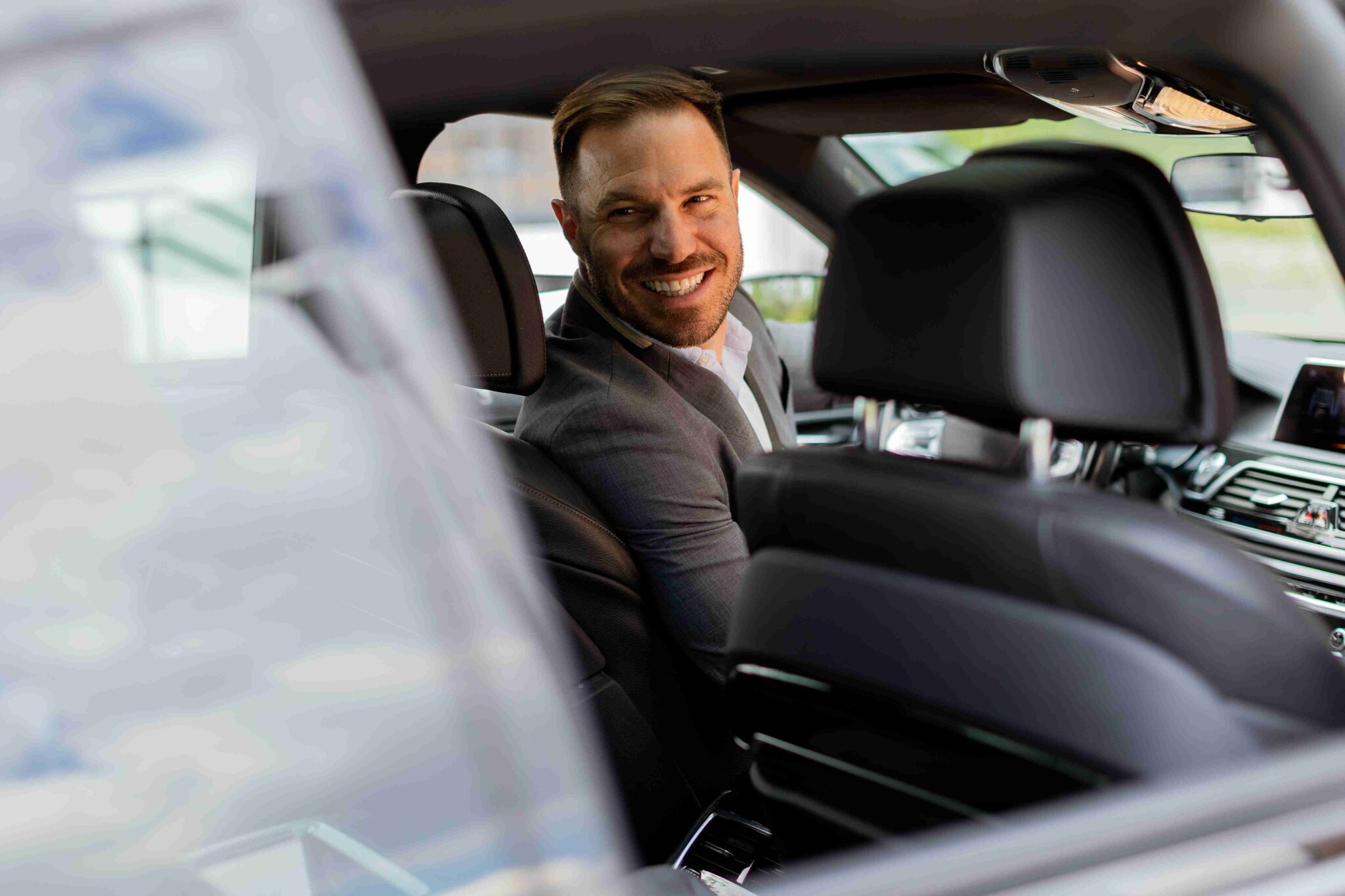Experiences welcoming smile from a joyful driver in a luxury s 2025 02 22 11 11 49 utc 11zon